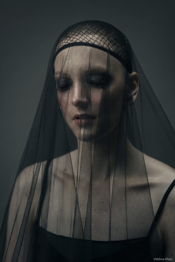 portrait of gillian in a black skull cap and black netting like a veil