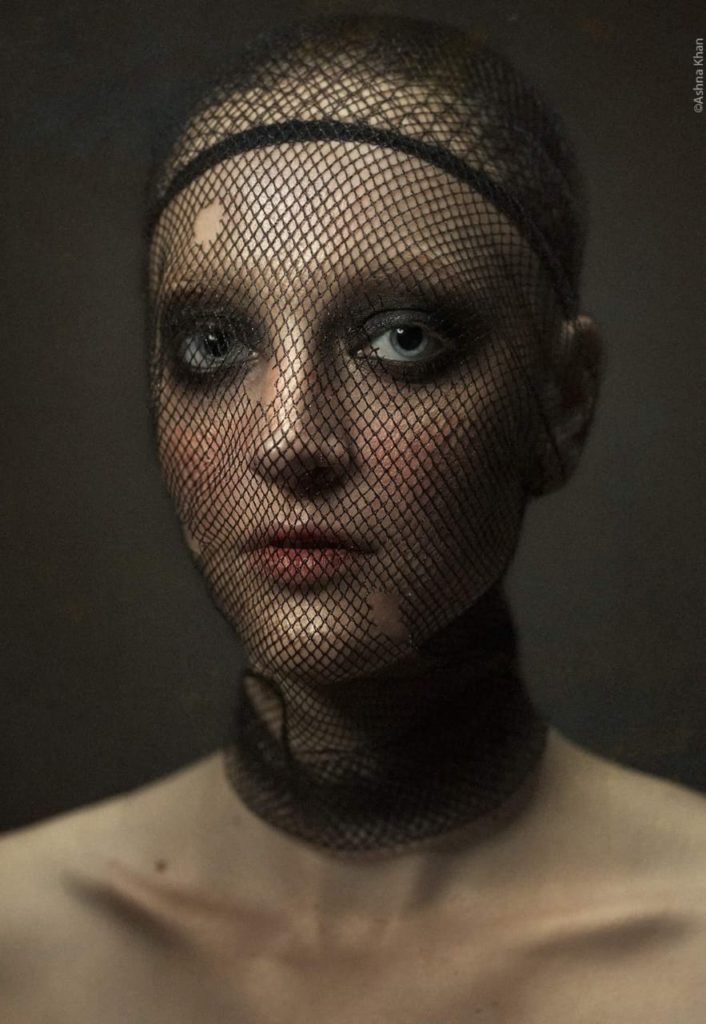 Portrait of Gillian in a skull cap and black netting over her face