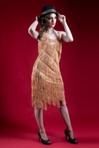 Gillian as a woman in a flapper dress holding a fedora