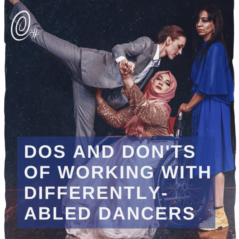 Gillian held by a dancer in a wheelchair with other dancer behind looking on