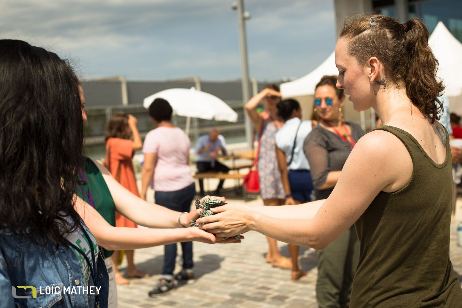 Gillian performing outside handing something to a bystander